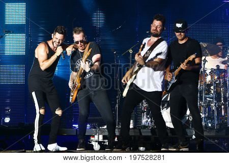 TWIN LAKES, WI-JUL 22: (L-R)  Thomas Rhett, Josh Reedy, Travis Vance and Nathan Whitney perform at Country Thunder Music Festival on July 22, 2017 in Twin Lakes, Wisconsin.
