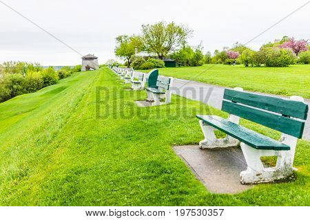 Quebec City Canada - May 30 2017: Martello tower watchtower in plaines d'Abraham with green grass field and many benches