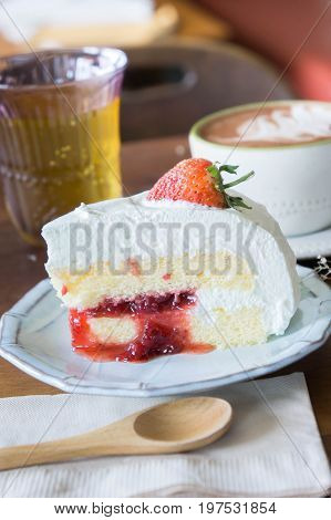 coffee cup and delicious cake strawberry and relax time moblie on table in coffee shop