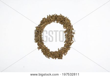 Written letters with carum carvi on white background