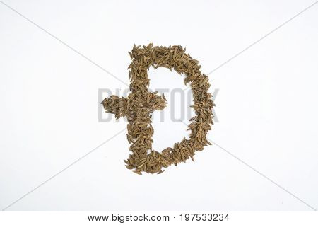 Written letters with carum carvi on white background