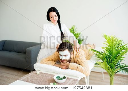 Man relaxing on massage table in spa salon