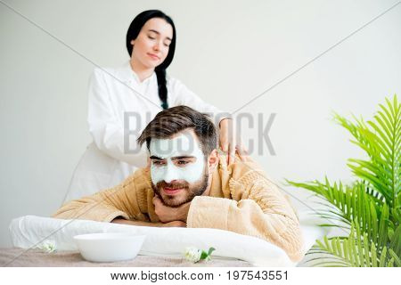 Man relaxing on massage table in spa salon