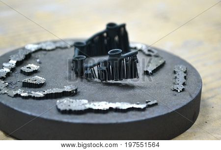 Object denture body printed on a laser sintering machine on the work disk close-up.