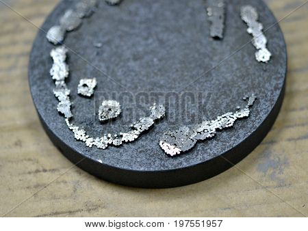 The working disk of the laser unit for melting the metal and the remains of the model printed on it