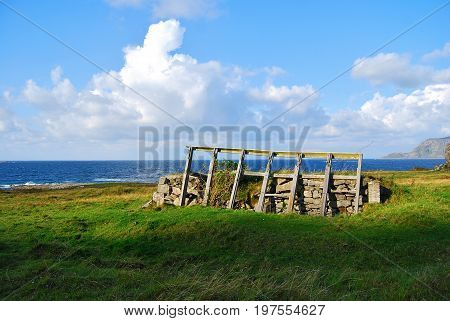 Old window frames on a Nordic Sea shore in meadow