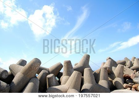 Concrete jetty surrounded by rocks - clear blue sky in Latvia (Ventspils)