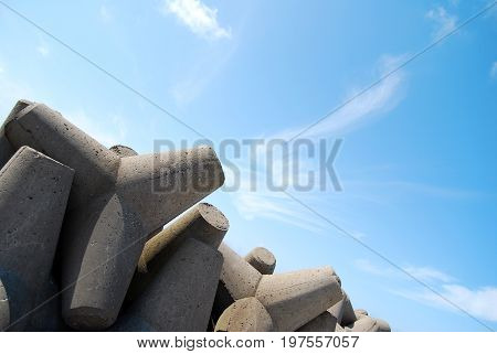 Concrete jetty surrounded by rocks - clear blue sky in Latvia (Ventspils)