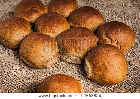 Freshly baked wheat-rye buns close-up. Delicious and healthy rustic bread