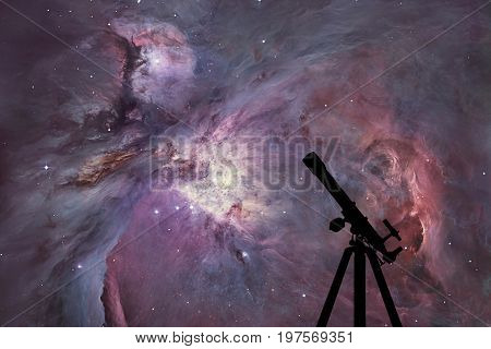 Space Background With Silhouette Of Telescope. The Orion Nebula Messier 42 Diffuse Nebula  In Conste