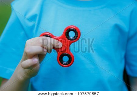 Little Girl Is Playing Spinner In Hand