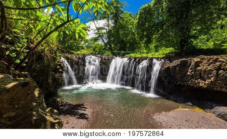 Vibrant Togitogiga falls with swimming hole on Upolu, Samoa Islands
