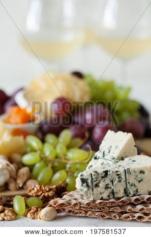 Cheese Plate Served With Grapes, Jam, Cured Melon, Crackers And Nuts