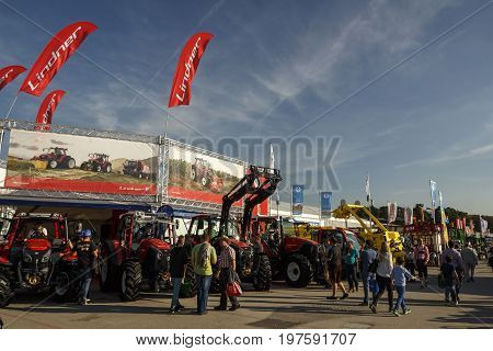 Munich, Germany - September 24, 2016: Agricultural machinery on the Theresienwiese during the Bavarian Agricultural Fair with unidentified people walking by the fair was in parallel during Oktoberfest