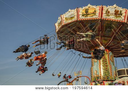 Munich, Germany - September 24, 2016: Carousel in motion with people flying through the air on Theresienwiese