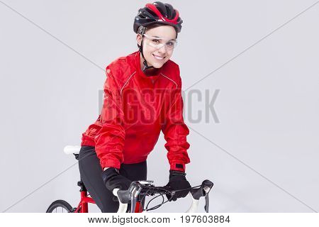 Cycling Concepts. Portrait of Caucasian Female Cyclist Equipped in Cycling Outfit and Posing With Road Bike In Studio.Horizontal Image Orientation