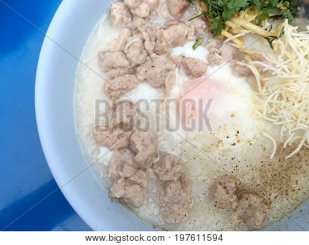 Traditional Thai Porridge Rice Gruel In White Bowl, Congee. In The Street Night Market.