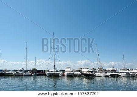 beautiful yachts staying on a pier background
