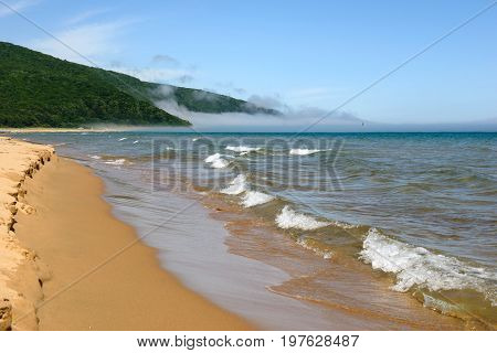 Sea, sand and fog in sunny day beautiful landscape