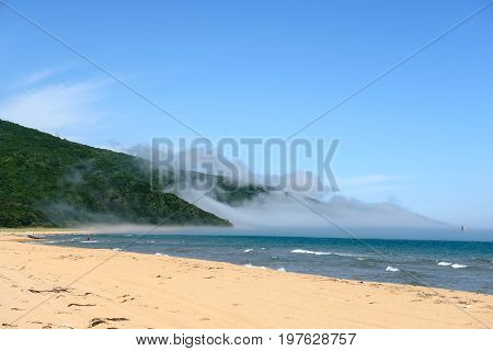 Sea, sand and fog in sunny day beautiful landscape