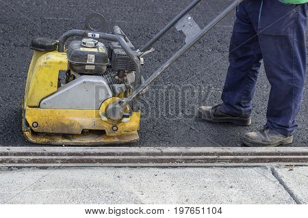 Road Repairing With Vibrating Compactor Plate