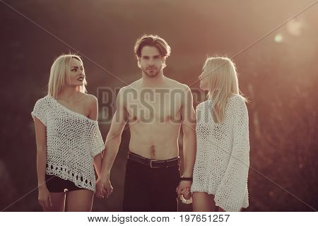 Beauty and fashion. Blonde and guy with athletic chest. Man with muscular body with twins. Girl and women with boyfriend outdoor. Love and romance.