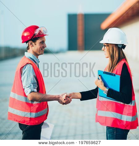 Handhaking on construction siteoutdoors toned image ,selective focus