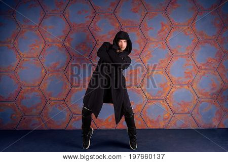 Young dancer standing on his tiptoes. Urban style
