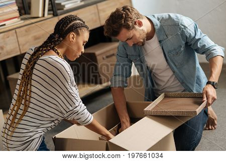 Put it inside. Serious people sitting on the floor and collecting their thing into box while going to change their flat