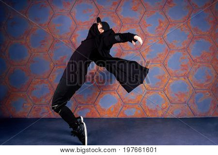 Young dancer standing on his tiptoes. Urban style
