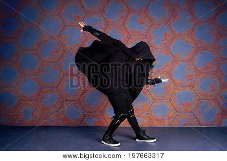Young dancer dancing near the wall. Urban style