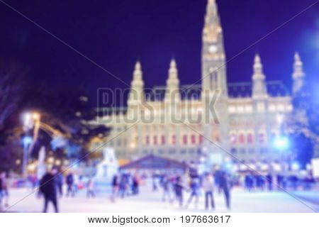 abstract blurred: people skate on the ice in the night city Europe