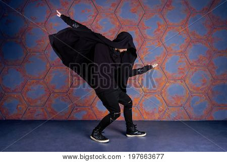 Young dancer dancing near the wall. Urban style