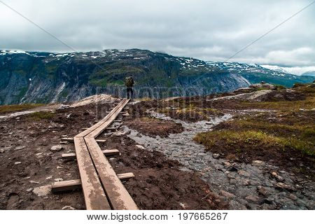 People walk the trail to Troll's Tongue Trolltunga rock in Hordaland county, Norway. The 22km trail to Trolltunga is among most visited in Norway.