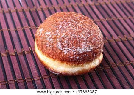 Homemade Doughnuts with Jelly filled and powdered sugar on Bamboo tablecloth. Selective focus