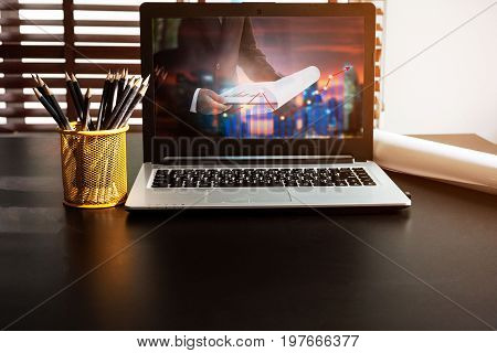 Business computer concept.Comfortable working place. Laptop with blank screen on table.