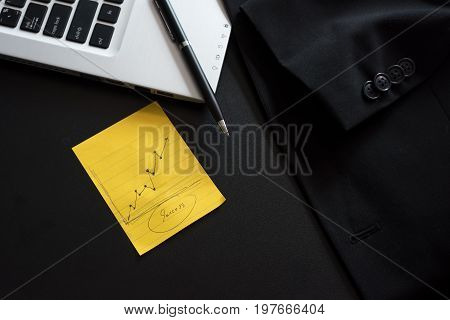 Business computer with note paper on table