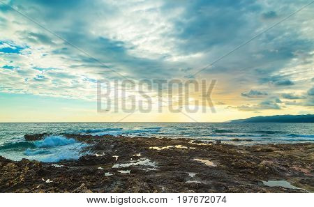 Sunset with clouds and sea waves, Crete, Greece