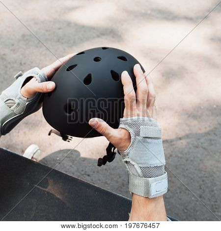 Skateboard halmet and gloves acessrise. Head and hands care protection from injoury. Extreme sport headwear stuff for skater