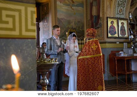 Alchevsk, Ukraine - April 28, 2017: Wedding Ceremony For Newlyweds In The Church