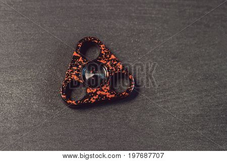 Famous Fidget Spinner Stress Relieving N A Black Wooden Background