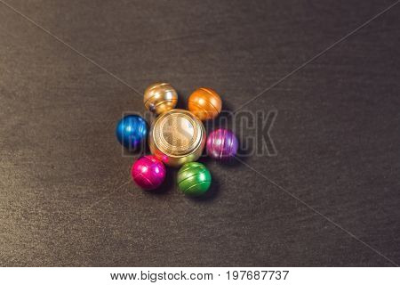 Famous Fidget Spinner Stress Relieving N A Black Wooden Background