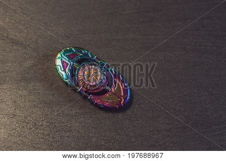 Famous Fidget Spinner Stress Relieving N A Black Wooden Background