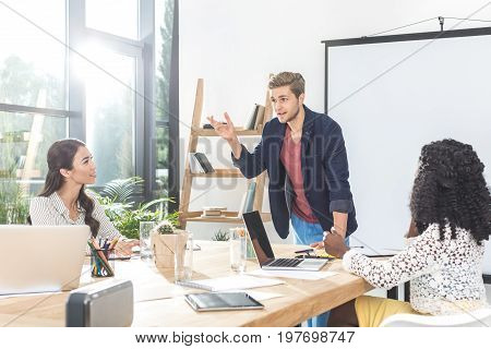 multiethinc business coworkers having conversation during conference in office