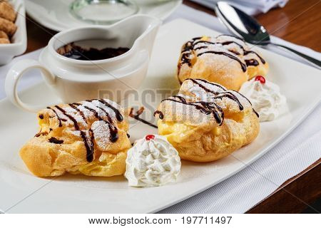 Eclairs with the dark hot chocolate and beze