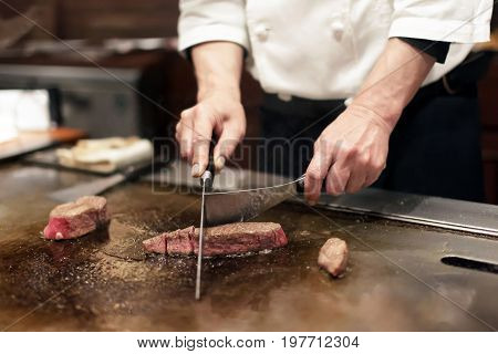 Chef Preparing Beef and Side at Restaurant