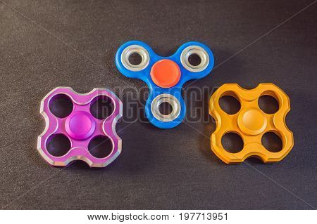 Famous Fidget Spinner Stress Relieving N A Black Wooden Background