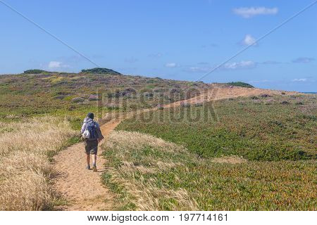 Girl hiking in Trail over the cliffs in Porto Covo Alentejo Portugal