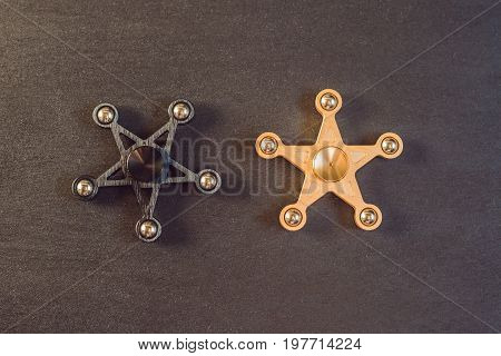Famous Fidget Spinner Stress Relieving N A Black Wooden Background