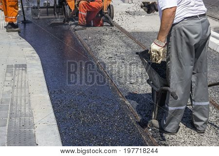 Workers Laying Stone Mastic Asphalt